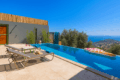 Villa Happy Vibes – Private pool honeymoon villa in Kalkan Akbel with stunning sea view, sun loungers, and modern holiday design.