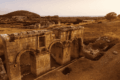 Ancient Roman gate ruins at Patara Ancient City in Antalya, Turkey, surrounded by nature at sunset